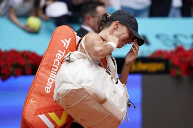 Tennis - Madrid Open - Park Manzanares, Madrid, Spain - April 25, 2026 Poland's Iga Swiatek looks dejected after losing in her round of 32 match against Ann Li of the US. REUTERS/Ana Beltran