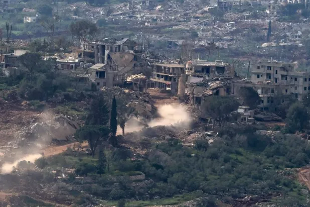 Israeli military vehicles maneuver on the Lebanese side of the border, as seen from the Upper Galilee in northern Israel, 27 April 2026. (EPA)