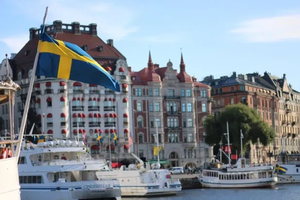 A Swedish flag flutters in front of residential houses in Stockholm, Sweden, September 14, 2023. (Reuters)