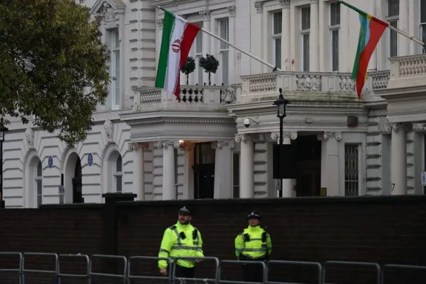 Police officers stand guard outside the Iranian embassy as demonstrators continue protesting outside during a rally in support of nationwide protests in Iran, in London, Britain, January 13, 2026. (Reuters)