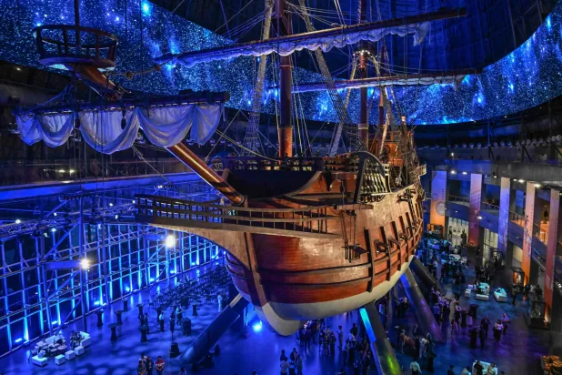This photo taken on April 23, 2026 shows visitors under the Galeon Espiritu Santo, a full-scale representation of a 17th century galleon, on display at the Museo del Galeon in Manila. (Photo by Jam STA ROSA / AFP)