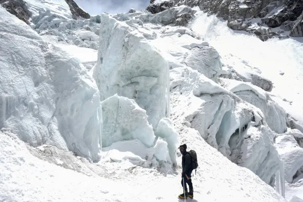 A member of expedition team stands at Khumbu Icefall in Solukhumbu district, also known as the Everest region, Nepal, April 22, 2026. REUTERS/Purnima Shrestha