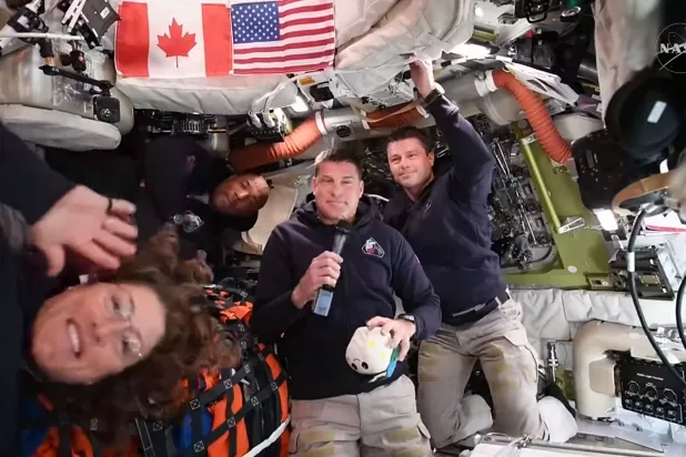 This screengrab from a NASA live broadcast video shows (L-R) NASA astronaut and Artemis II Mission Specialist Christina Koch, NASA astronaut and Artemis II pilot Victor Glover, Canadian Space Agency astronaut Artemis II Mission Specialist Jeremy Hansen and NASA astronaut and Artemis II Commander Reid Wiseman during a press call as they travel to the Moon in the Orion spacecraft, on April 3, 2026.  (Photo by NASA / AFP) 