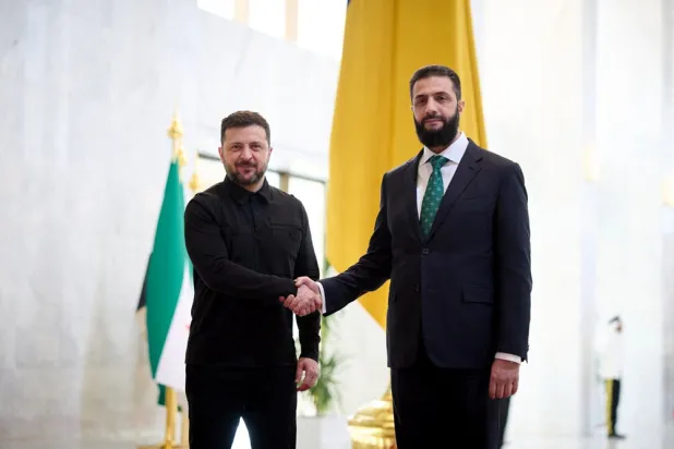 This handout photograph taken and released by the Ukrainian Presidential Press Service on April 5, 2026 shows Ukraine's President Volodymyr Zelenskyy (L) and Syrian President Ahmed al-Sharaa shaking hands during their meeting in Damascus. (Handout / Ukrainian Presidential Press Service / AFP) 