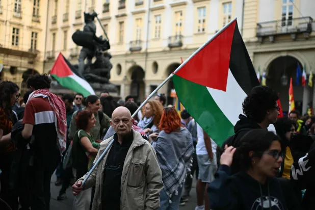 Protesters hold Palestinian flags during a demonstration to condemn the interception of the Global Sumud Flotilla by the Israeli army, in Turin on April 30, 2026. (Photo by MARCO BERTORELLO / AFP)