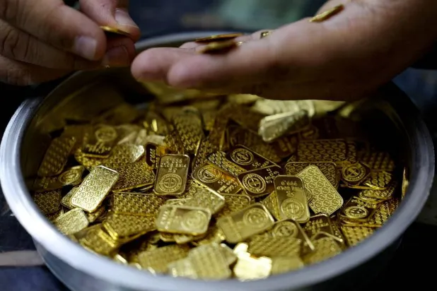 A jeweller holds gold bars in Cairo, Egypt, March 9, 2026. (Reuters)