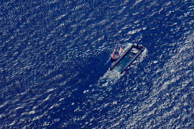 01 May 2026, Denmark, Skagen: An aerial view of the the humpback whale towed in its barge by the tugboat Fortuna B along the Danish coast, just south of Skagen in the Skagerrak, through the Baltic Sea. (dpa)