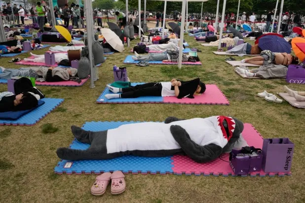  Participants take a nap during the 2026 Hangang Nap Competition at Yeouido Hangang Park in Seoul, South Korea, Saturday, May 2, 2026. (AP) 