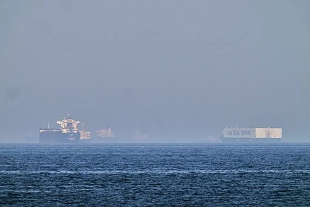  A tanker, left, and a car carrier are anchored at sea in the Gulf of Oman near the Strait of Hormuz, as seen from the coast near Khor Fakkan, United Arab Emirates, Friday, May 1, 2026.(AP) 