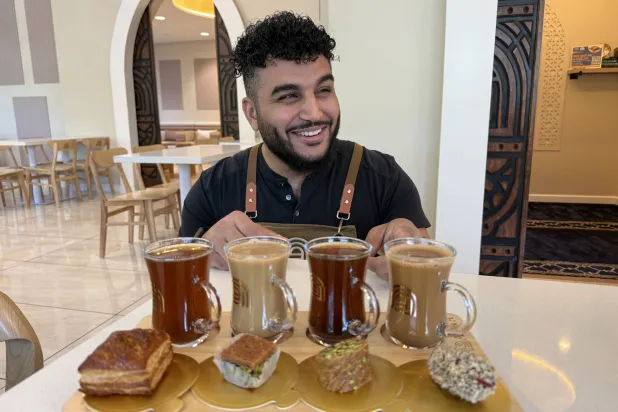 Franchisee Ahmad Badr serves a drink and treat sampler at Arwa Yemeni Coffee on April 6, 2026, in Sunnyvale, Calif. (AP) 