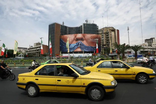 People drive past an anti-US billboard depicting US President Donald Trump and the Strait of Hormuz, in Tehran, Iran, May 2, 2026. Majid Asgaripour/WANA (West Asia News Agency) via REUTERS 