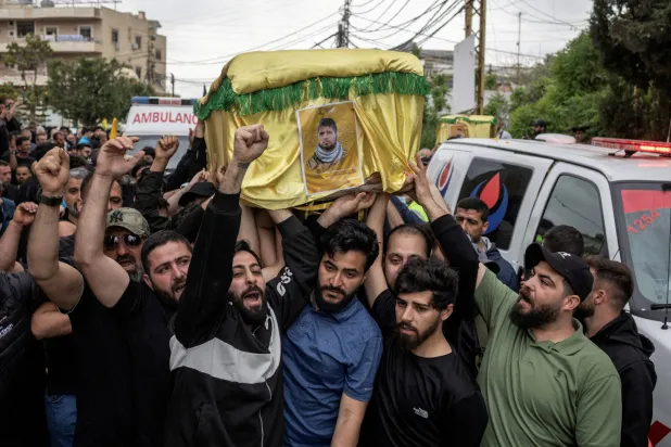 FILE PHOTO: Mourners carry coffins during the funeral of four Hezbollah fighters and two civilians, amid a temporary ceasefire between Lebanon and Israel, in the village of Maaroub, southern Lebanon, April 26, 2026. REUTERS/Marko Djurica/File Photo