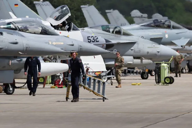 Combat aircraft from a NATO country stand in front of a hangar during a fighter plane maneuver exercise at the American military's Ramstein Air Base, near Ramstein-Miesenbach, Germany, June 6, 2024. (Reuters)