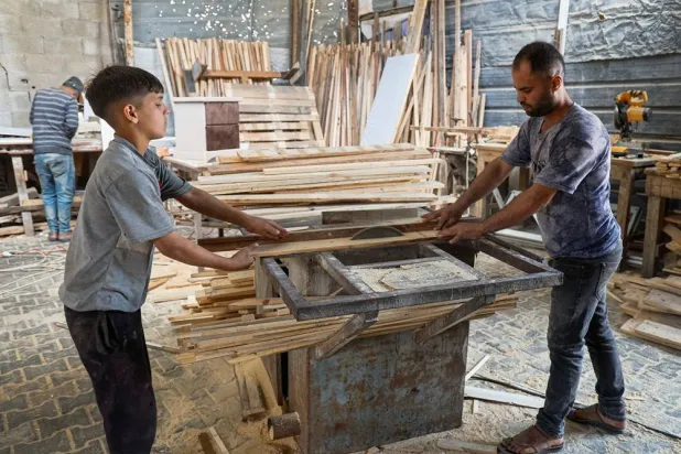  Palestinian carpenter Mohammed Wafi builds furniture from recycled wooden pallets in his workshop amid shortages of materials in Khan Younis, in the southern Gaza Strip, May 2, 2026. (Reuters)
