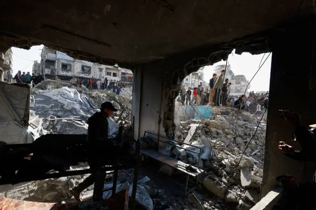 Palestinians inspect the site of an Israeli strike that targeted a police post, in Gaza City, May 5, 2026. (Reuters)