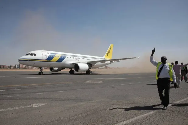 Khartoum International Airport ground workers greet the first domestic Sudan Airways flight landing from Port Sudan, in Khartoum, Sudan, on Feb. 1, 2026. (AP) 