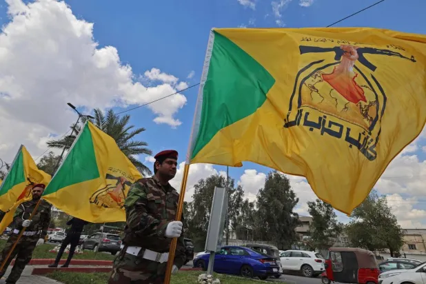 Members of Iraq's pro-Iran paramilitary group Kataeb Hezbollah mourn a comrade who was killed in a strike in Basra, during the funeral in Baghdad on April 8, 2026. AHMAD AL-RUBAYE / AFP/File
