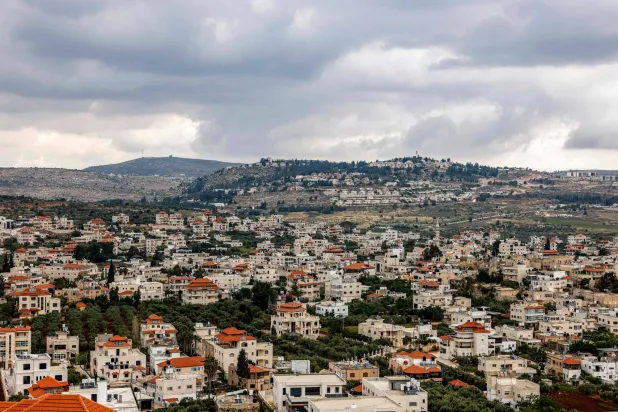 The Palestinian village of Turmus Ayya (foreground) and the Israeli settlement of Shilo (background), north of Ramallah in the Israeli-occupied West Bank, are pictured on May 6, 2026. (Photo by Zain JAAFAR / AFP)