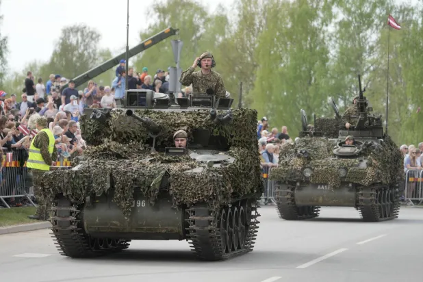 Latvian servicemen with their armored vehicles participate in a military parade in Aizkraukle, Latvia, 04 May 2026. EPA/VALDA KALNINA