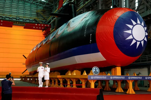FILE PHOTO: Members of the navy pose for pictures next to Narwhal, Taiwan's first domestically built submarine, after its launching ceremony in Kaohsiung, Taiwan September 28, 2023. REUTERS/Carlos Garcia Rawlins/File Photo