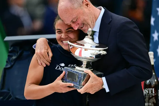 (FILES) Italy's Jasmine Paolini (L) and Angelo Binaghi, President of the Italian Tennis Federation, celebrate after victory in her women's singles final match against US's Coco Gauff during the WTA Rome Open tennis tournament at Foro Italico in Rome on May 17, 2025. (Photo by Tiziana FABI / AFP)