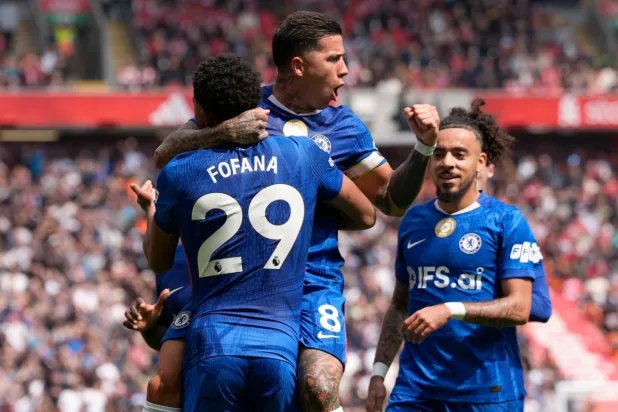 Chelsea's Enzo Fernandez (top) celebrates with team-mate Wesley Fofana after scoring their side's first goal of the game during the Premier League soccer match between Liverpool and Chelsea in Liverpool, England, Saturday, May 9, 2026. (Peter Byrne/PA via AP)