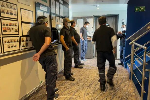 Crew members of the hantavirus-stricken cruise ship, MV Hondius, wait their turns for a first interview with epidemiologists, during the voyage to Spain’s port of Tenerife, May 6, 2026. (AP Photo)
