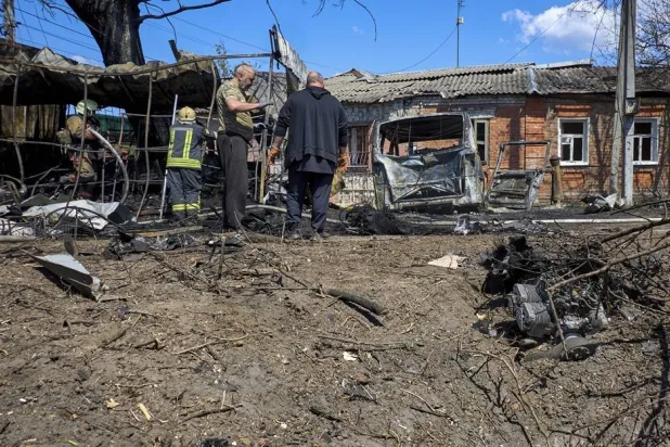 A drone engine lies near as Ukrainian rescuers and local people inspect the site of a Russian strike on a residential area in Kharkiv, Ukraine, 07 May 2026, amid the ongoing Russian invasion. (EPA)