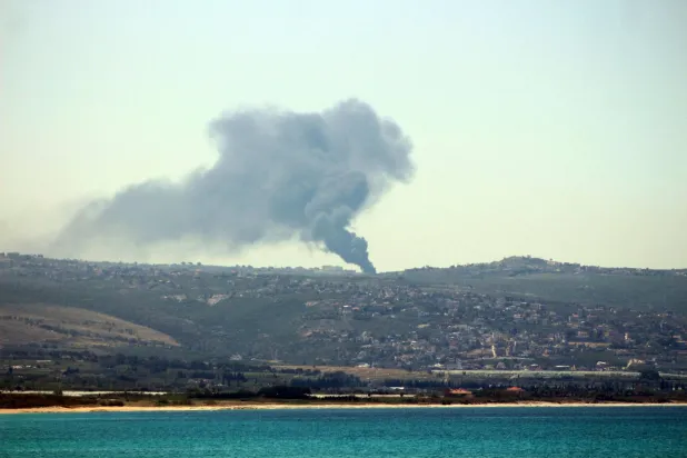 This photograph taken from the southern Lebanese area of Tyre shows smoke rising from the site of Israeli bombardment that targeted the village of Tair Harfa on May 11, 2026. (AFP)