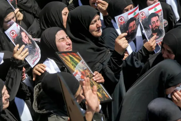 Women mourn during the funeral procession for three Lebanese Civil Defense members killed in an Israeli airstrike on the village of Majdal Zoun in southern Lebanon. (dpa) 