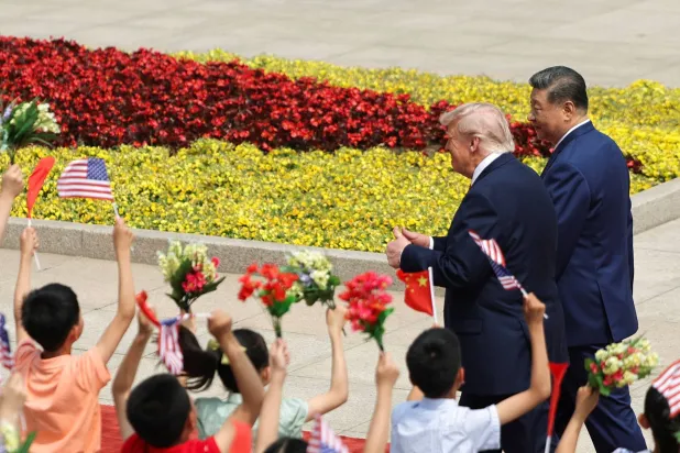 Children hold Chinese and US flags, as US President Donald Trump participates in a welcome ceremony with Chinese President Xi Jinping at the Great Hall of the People in Beijing, China, May 14, 2026. REUTERS/Maxim Shemetov/Pool