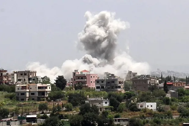 Smoke rises from the site of an Israeli airstrike that targeted the southern village of Al-Halloussiyah on May 13, 2026. (AFP)