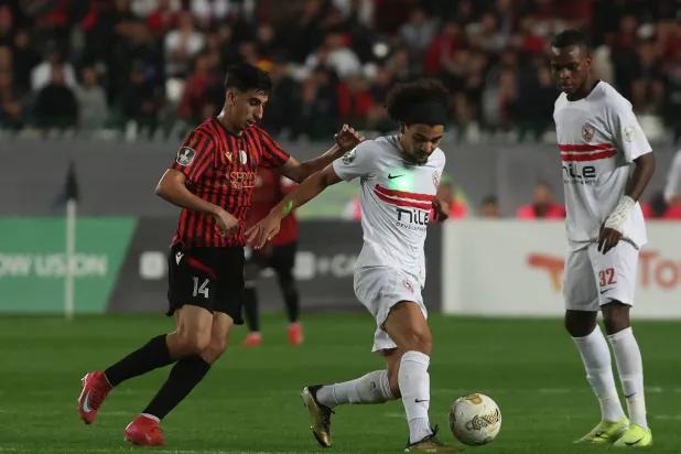 USM's Brahim Benzaza (L) in action against Zamalek's Adam Kaied (C) during the CAF Confederation Cup final, 1st leg soccer match between USM Alger and Zamalek, in Algiers, Algeria, 09 May 2026. (EPA)