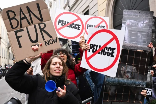Protestors hold signs reading "Ban fur" ahead of the Giorgio Armani womens's ready-to-wear Fall/Winter 2026 collection fashion show as part of the Milan Fashion Week, in Milan on March 1, 2026. (AFP)