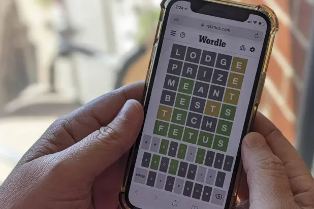 This photo illustration shows a person playing online word game Wordle on a mobile phone. Michael Draper / AFP/File
