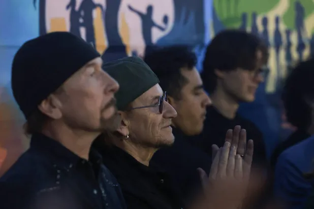 Irish rock band U2 lead singer Bono applauds beside guitarist The Edge during the match between Indonesia and Argentina for the Boys’ Shield final at the fifth Street Child World Cup football tournament, bringing together street-connected young people from 28 countries, in Texcoco, near Mexico City, Mexico, May 14, 2026, as the 2026 FIFA World Cup approaches in Mexico. REUTERS/Henry Romero