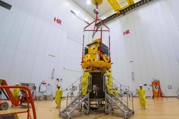This photograph shows the Smile spacecraft (gold) fixed to a Vega-C rocket adaptor (black cone) on 25 March 2026, in Kourou, French Guiana, in preparation for liftoff from Europe's Spaceport. (Photo by ESA / AFP)