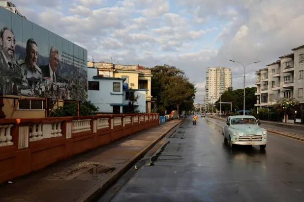  A vintage car passes by images of late Cuban President Fidel Castro, Cuba's former President Raul Castro and Cuba's President Miguel Diaz-Canel displayed on a billboard in Havana, Cuba, May 15, 2026. (Reuters)