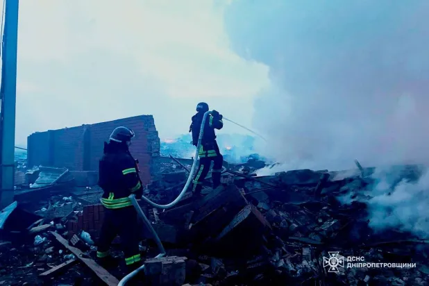 In this photo provided by the Ukrainian Emergency Services on Monday, May 18, 2026, rescue workers put out a fire of a residential building destroyed after a Russian strike on Dnipro, Ukraine. (Ukrainian Emergency Service via AP) 