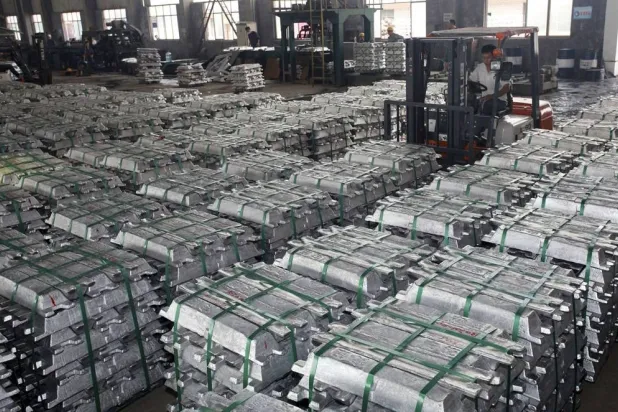 A worker drives a forklift to transport aluminum bars at a factory in Anshun, Guizhou province, China, in this July 1, 2013. (Reuters)