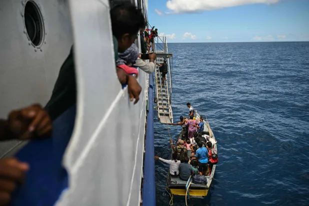 This photograph taken on March 30, 2026 shows passengers boarding the MV Kalighat vessel near Chowra in the waters of India's Andaman and Nicobar Islands. (AFP)