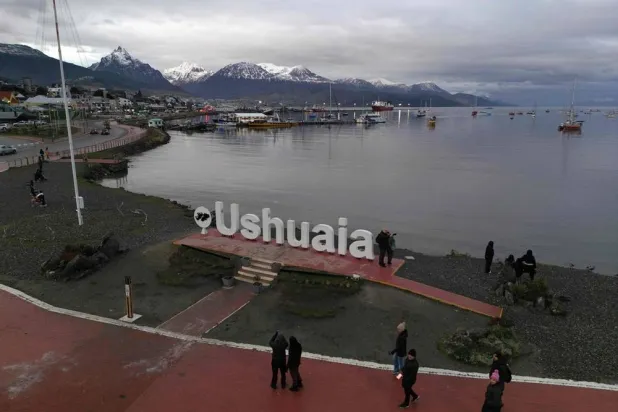 This aerial view shows tourists taking photos at the Ushuaia sign in Ushuaia, Tierra del Fuego, Antartida e Islas del Atlantico Sur, Argentina, on May 17, 2026. (AFP)
