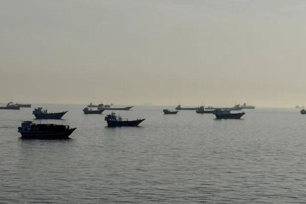 Vessels are seen anchored in the Strait of Hormuz, off the port city of Khasab on Oman's northern Musandam Peninsula on May 17, 2026. AFP
