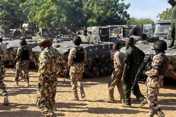 Nigerian soldiers walk past military tanks prepared for deployment during a tour of the Theater Command Operation Lafiya Dole by Nigeria's Chief of Army Staff at Maimalari Cantonment in Maiduguri, Borno State, Nigeria, November 7, 2025. (Reuters)