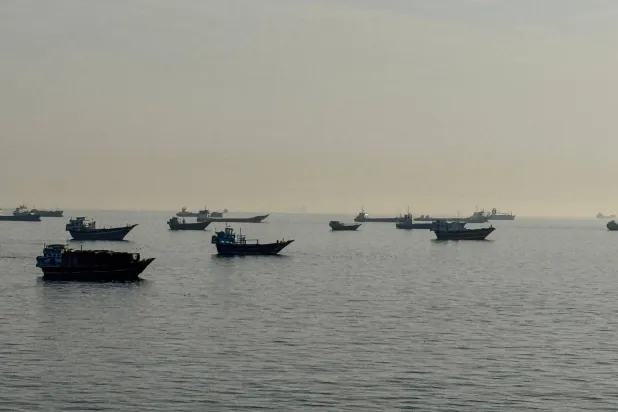 Vessels are seen anchored in the Strait of Hormuz, off the port city of Khasab on Oman's northern Musandam Peninsula on May 17, 2026. (AFP)