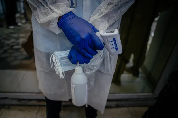 A health worker monitors visitors arriving at the Rodolphe Merieux Laboratory, National Biomedical Research Institute (INRB) in Goma, on May 19, 2026. (AFP)