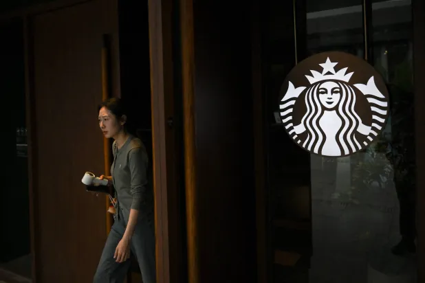 A customer leaves a Starbucks coffee shop in Seoul on May 19, 2026. (AFP)