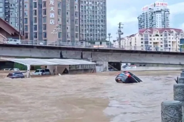 Cars partially submerged in floodwaters after heavy rainfall in Duyun, Guizhou Province, China, May 19, 2026, in this still image obtained from a social media video. (Social Media/via Reuters)
