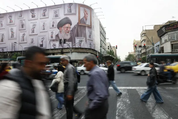 People walk near a billboard with an image of the late Iranian Supreme Leader Ali Khamenei, in Tehran, Iran, May 19, 2026. Majid Asgaripour/WANA (West Asia News Agency) via REUTERS 