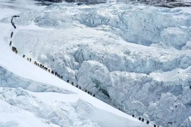 Climbers walk in a long queue as they head to summit Mount Everest in the Solukhumbu district, also known as the Everest region, Nepal, May 18, 2026. REUTERS/Purnima Shrestha/File Photo 
